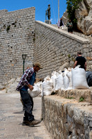 This poor guy, however, is hand carrying bags of stone and concrete.